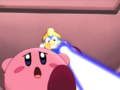 Kirby is chased by King Dedede's portrait as it shoots at him with a ray gun.