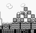 Kirby whacks a Star Block formation with his Parasol.