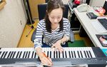 Megumi Ohara writing music on her Yamaha NP-30.