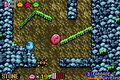 Kirby rolls down a cave chute alongside a Roly-Poly in Cabbage Cavern.