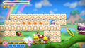 Blazing through barricades and enemies using the Candy's effects in Kirby and the Rainbow Curse