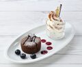 The "Meta Knight Chocolate fondant" dessert from the Kirby Café includes a Galaxia topper