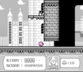 Kirby squeezes into the entrance to the colorless castle.