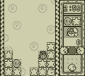 Tick-Tock Jr. as he appears in the Game Boy version of Kirby's Star Stacker Time Attack mode.