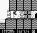 Kirby busts through a deep barricade of Star Blocks to find the door.