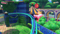 Coaster-Mouth Kirby tilting to grab a red Star Coin while on the track in Welcome to Wondaria