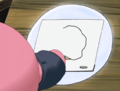 Kirby attempts to draw himself at his writing desk.