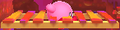 Kirby passing through a seemingly solid bridge in Kirby: Triple Deluxe