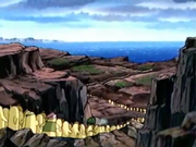 The people of Dream Land head down the rocky cliffs to the shore.
