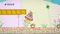 Kirby in Saucer form with the capture beam activated in a pre-release version of Flower Fields