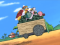 Kirby latches onto the watermelon cart, pushing King Dedede and Escargoon down with it.