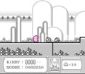 Kirby eats some Waddle Dees on the monochrome path.