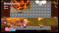 Kirby keeps on his feet to avoid being intercepted by a magma boulder.