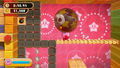 Kirby prepares to throw the Balloon Bomb.