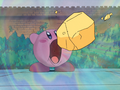 Kirby inhales a piece of debris while trying to help the Waddle Dees.