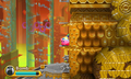 Kirby scales the steep entrance to the golden temple in the jungle.