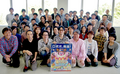 HAL Laboratory staff pictured with a Kirby: Planet Robobot poster