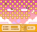 Hi-Jump Kirby busts through a large checkered blockade of Star Blocks.