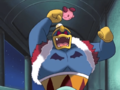 A helpless Kirby is beat upon by the monstrous King Dedede.