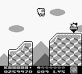 Kirby jumping over a bottomless pit from Kirby's Dream Land 2