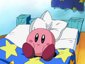 Kirby sitting on his bed inside his house