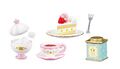 "Kirby Cake" miniature set from the "Kirby Garden Afternoon Tea" merchandise line, featuring a Kirby cake topping and on the tea container