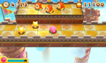Kirby standing near some Drop Stars produced by the impact of spears from Spear Waddle Dees in Kirby's Blowout Blast