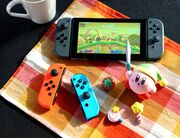 Promotional photo featuring Kirby figurines and Kirby Star Allies onscreen