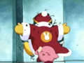 Kirby retrieves his lollipop after Dedede crashes into the wall.